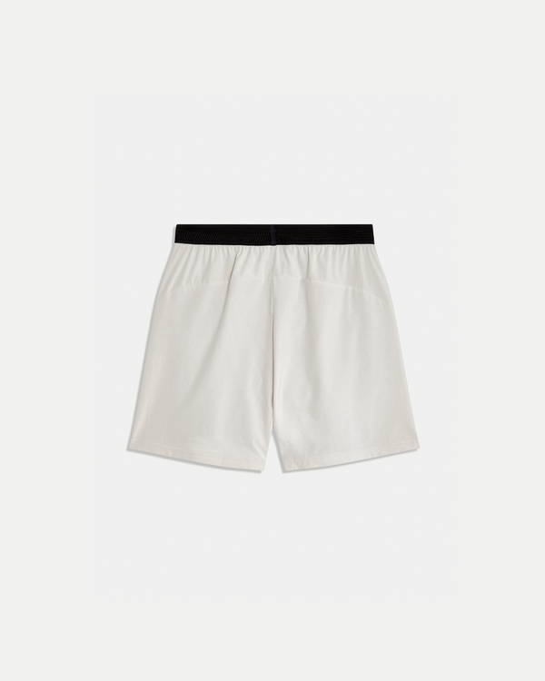 Men's 6 inch training short in color nude with black lining.