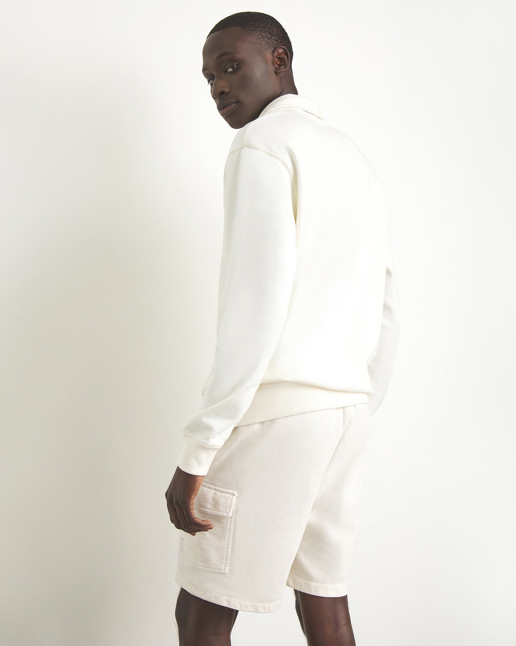 Men's 8 inch cargo short in color off-white with a relaxed fit in jersey cotton.
