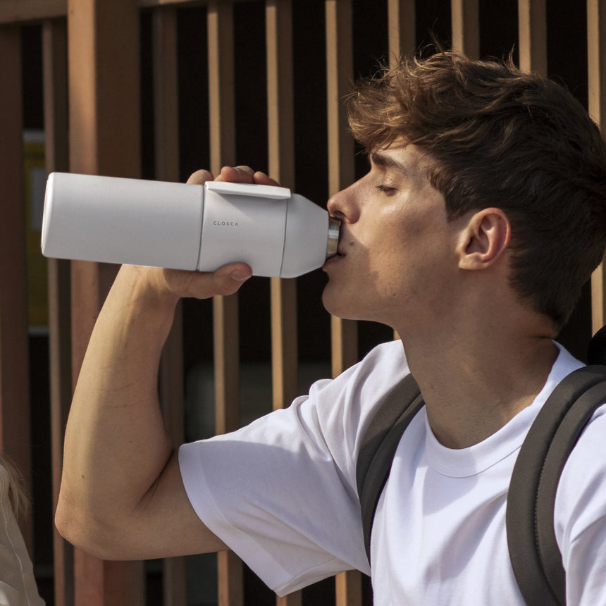 20oz Reusable thermos bottle in white. Patented silicone flap making it hands free with a soft touch.