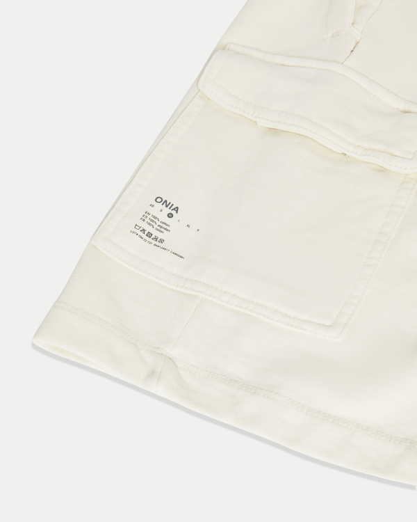 Men's 8 inch cargo short in color off-white with a relaxed fit in jersey cotton.