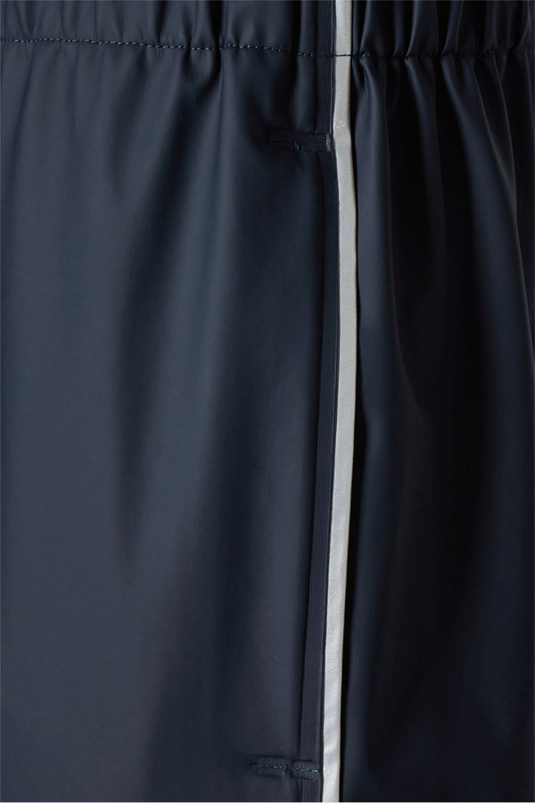 Men's waterproof lightweight track pants in navy with reflective side stripe