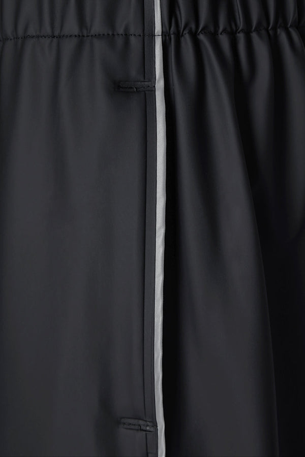 Men's waterproof lightweight track pants in black with reflective side stripe.