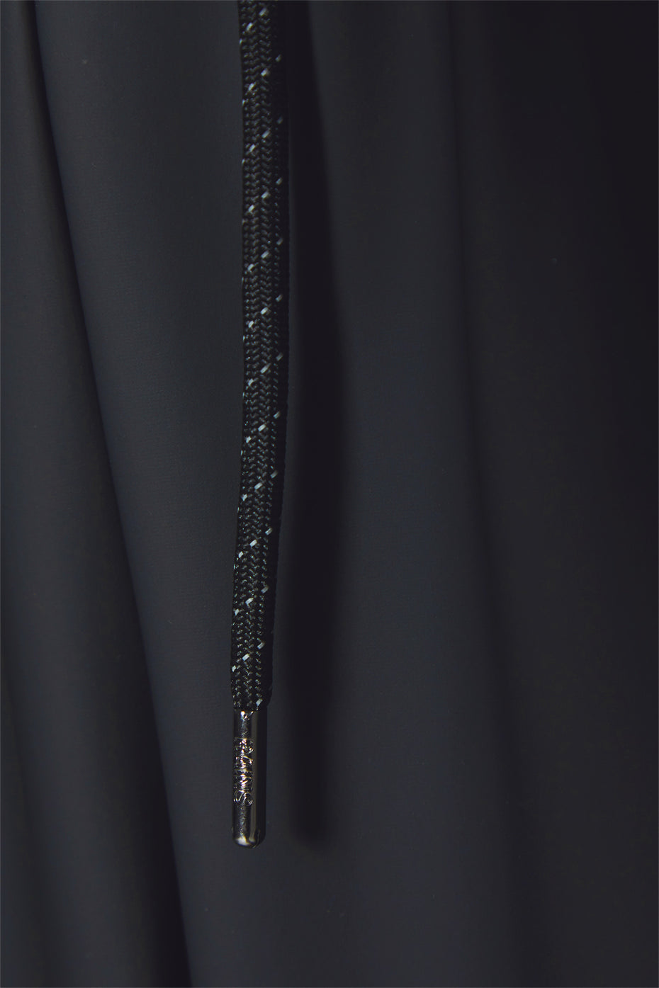 Men's waterproof lightweight track pants in black with reflective side stripe.