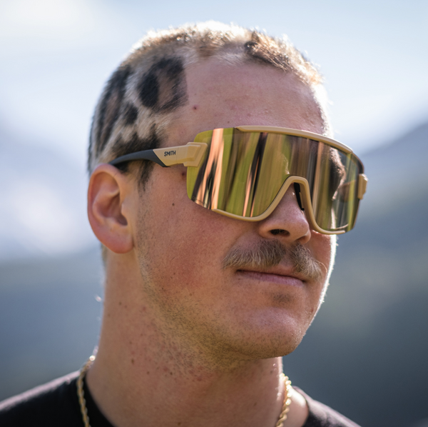 Men's active sunglasses that offer protection and have the coverage of goggles. An easy-to-wear style with a non-slip nose piece in metallic gold/black.