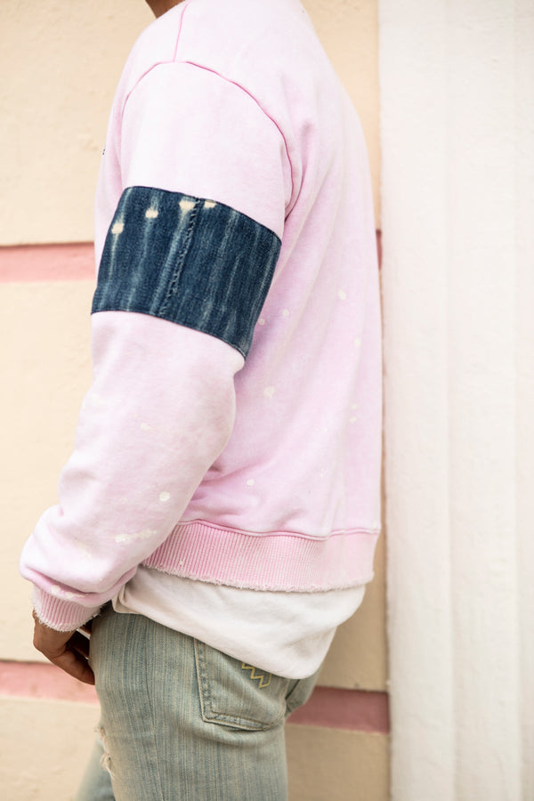 Men's oversized crewneck sweater in pink with artistic features in 100% cotton.